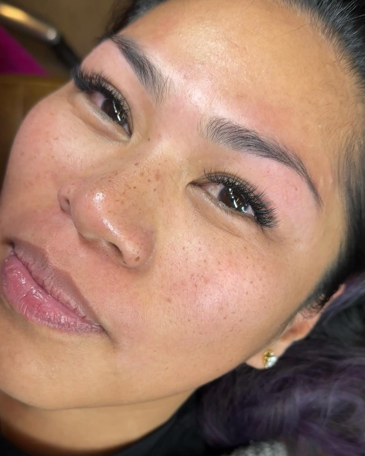 close up of olive skinned woman with lashes and brows waxed