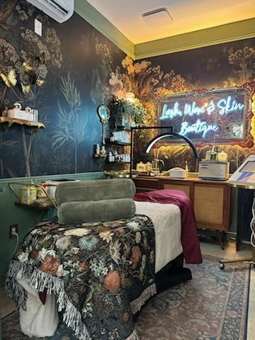 lash and brow treatment room, dark moody colors and lots of floral